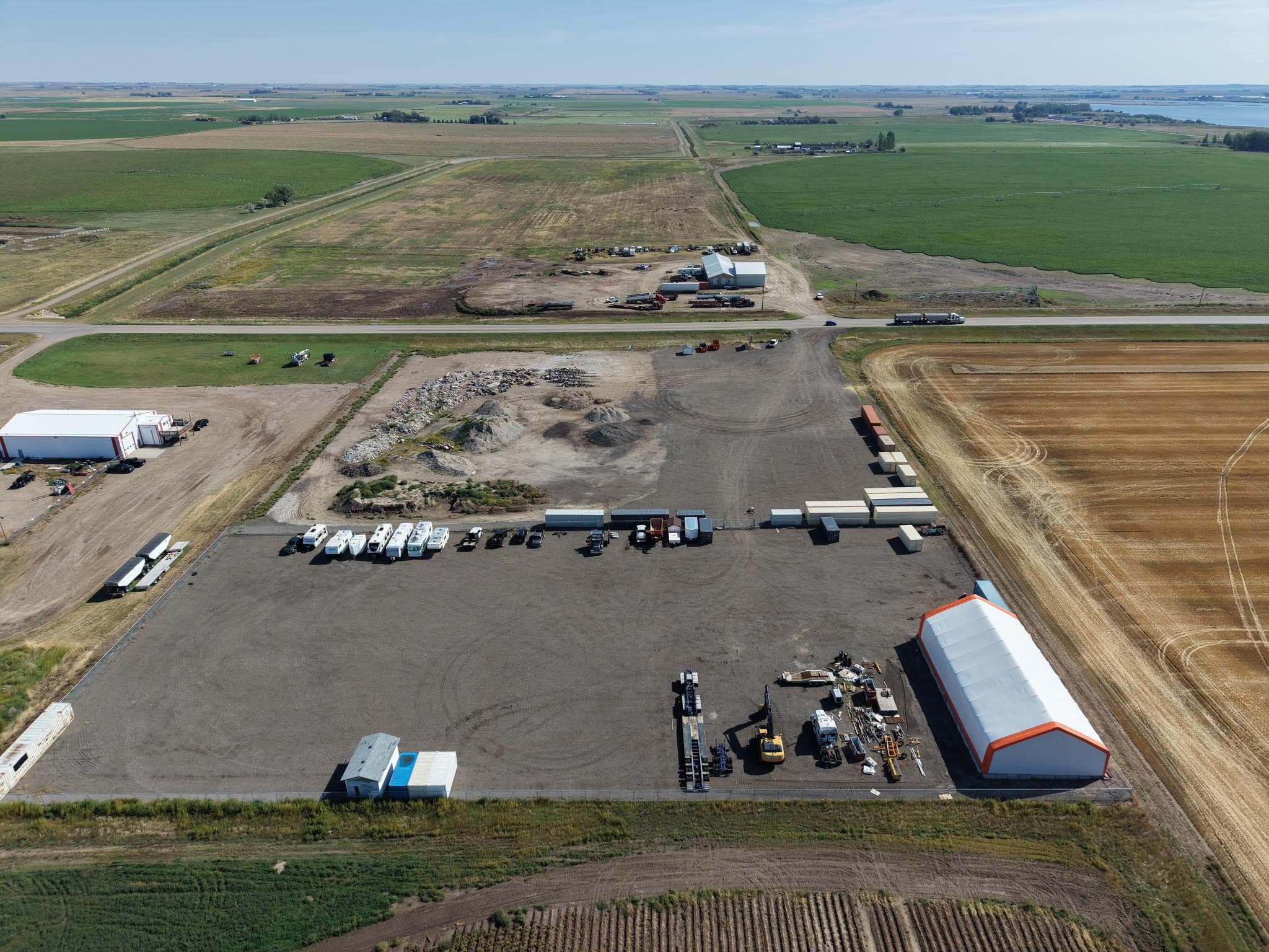 Aerial view of the storage lot beside Highway 36 and the surrounding Taber farmland
